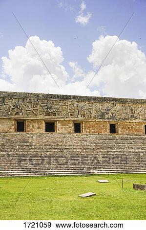 Stock Photo - Detail of Governor's Palace against cloudy sky, Uxmal, Yucatan, Mexico. Fotosearch