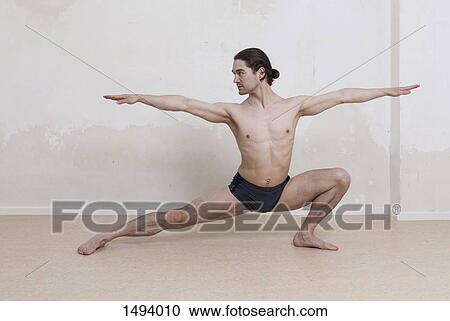 Determined man practicing yoga in warrior position against white background View Large Photo Image Stock Image - Determined man practicing yoga in warrior position against white background. Fotosearch