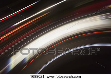Stock Image - Directly above shot of abstract light trails against black background. Fotosearch