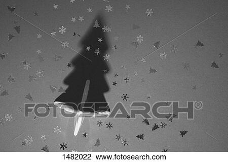 Stock Image - Directly above shot of Christmas tree and sequins on table. Fotosearch