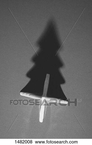 Stock Photo - Directly above shot of Christmas tree and its shadow on gray background. Fotosearch