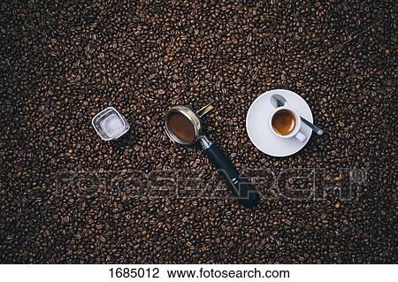 Directly above shot of espresso cup with filter and glass on roasted coffee beans View Large Photo Image Stock Image - Directly above shot of espresso cup with filter and glass on roasted coffee beans. Fotosearch