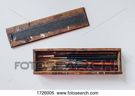 Stock Photography - Directly above shot of paintbrushes in wooden case over white background. Fotosearch