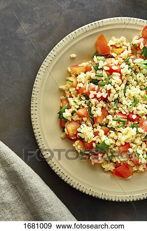 Stock Photo - Directly above shot of rice with chopped tomatoes in plate on table. Fotosearch