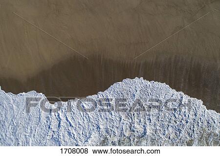 Directly above view of wave on shore at beach, Porto, Portugal View Large Photo Image Stock Photo - Directly above view of wave on shore at beach, Porto, Portugal. Fotosearch