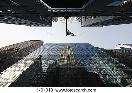 Directly below view of American Flag amidst modern office skyscrapers against sky, New York, USA View Large Photo Image Stock Photo - Directly below view of American Flag amidst modern office skyscrapers against sky, New York, USA. Fotosearch