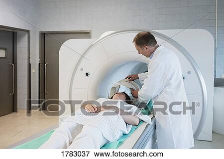 Doctor preparing patient for MRI in hospital View Large Photo Image Stock Photo - Doctor preparing patient for MRI in hospital. Fotosearch