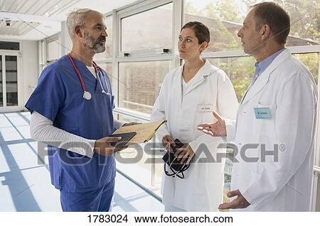 Doctors talking in hospital corridor View Large Photo Image Picture - Doctors talking in hospital corridor. Fotosearch