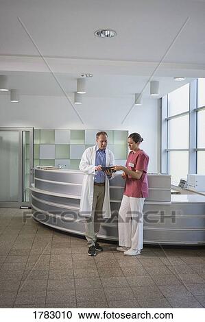 Doctors using digital tablet in hospital View Large Photo Image Stock Image - Doctors using digital tablet in hospital. Fotosearch