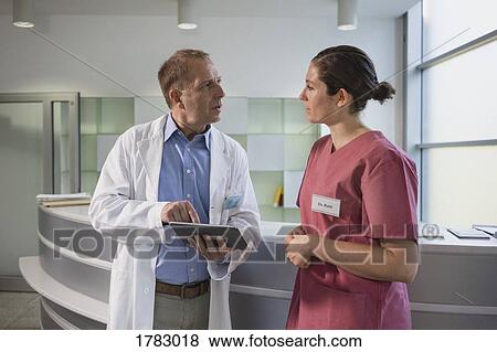 Doctors using digital tablet in hospital View Large Photo Image Stock Photo - Doctors using digital tablet in hospital. Fotosearch