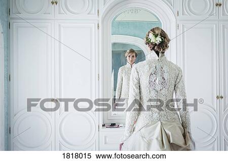Elegant bride in lace wedding dress at mirror View Large Photo Image Stock Photography - Elegant bride in lace wedding dress at mirror. Fotosearch