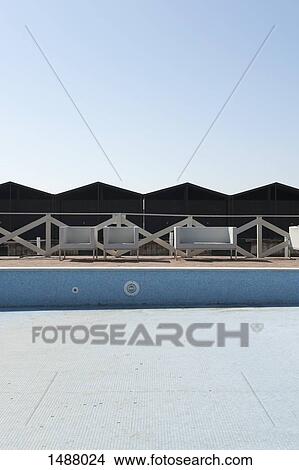 Empty swimming pool against clear sky View Large Photo Image Picture - Empty swimming pool against clear sky. Fotosearch