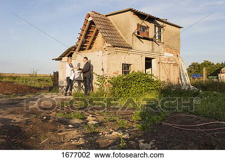 Estate agent shaking hands with buyer while standing against residential house View Large Photo Image Stock Image - Estate agent shaking hands with buyer while standing against residential house. Fotosearch