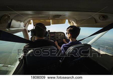 Father and son flying small airplane View Large Photo Image Stock Photo - Father and son flying small airplane. Fotosearch