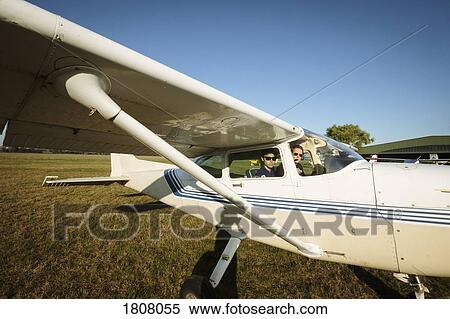 Father and son in small airplane in sunny field View Large Photo Image Stock Photography - Father and son in small airplane in sunny field. Fotosearch