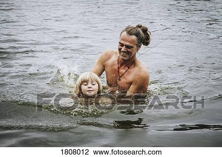 Father and son swimming in lake View Large Photo Image Stock Image - Father and son swimming in lake. Fotosearch