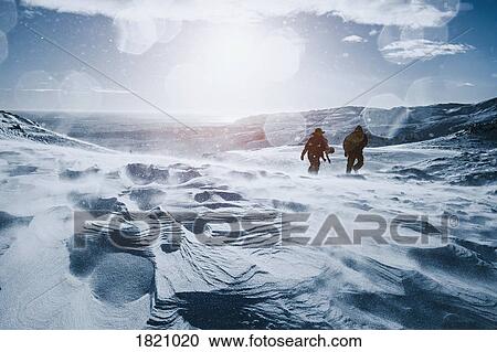Father and son walking along sunny, snow covered mountain, Reykjadalur, Iceland View Large Photo Image Stock Image - Father and son walking along sunny, snow covered mountain, Reykjadalur, Iceland. Fotosearch