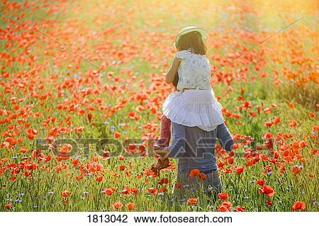 Father carrying daughter on shoulders in sunny, idyllic rural field with red poppy flowers View Large Photo Image Stock Image - Father carrying daughter on shoulders in sunny, idyllic rural field with red poppy flowers. Fotosearch