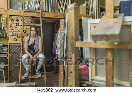 Female artist sitting on ladder in art studio View Large Photo Image Stock Image - Female artist sitting on ladder in art studio. Fotosearch