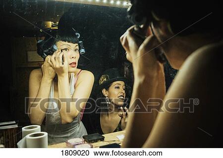 Female burlesque performers getting ready, applying makeup at dressing room mirror View Large Photo Image Stock Image - Female burlesque performers getting ready, applying makeup at dressing room mirror. Fotosearch
