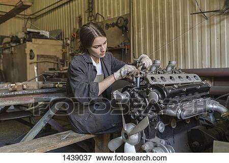 Female mechanic repairing car engine at garage View Large Photo Image Stock Photo - Female mechanic repairing car engine at garage. Fotosearch