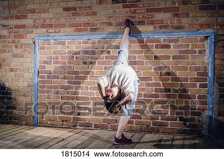 Female modern dancer performing against brick wall View Large Photo Image Picture - Female modern dancer performing against brick wall. Fotosearch