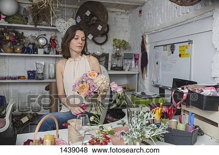 Female owner making flower bouquet at store View Large Photo Image Stock Photo - Female owner making flower bouquet at store. Fotosearch