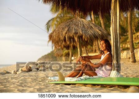 Female surfer with surfboard relaxing on sunny beach, Sayulita, Nayarit, Mexico View Large Photo Image Stock Photo - Female surfer with surfboard relaxing on sunny beach, Sayulita, Nayarit, Mexico. Fotosearch