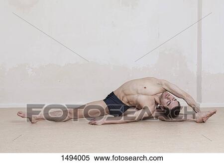 Flexible man performing revolved head-to-knee yoga pose View Large Photo Image Stock Photography - Flexible man performing revolved head-to-knee yoga pose. Fotosearch