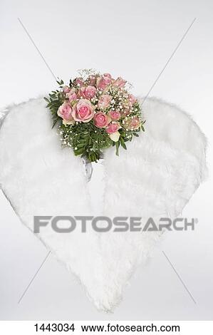 Picture - Flower bouquet and angel wings against white background. Fotosearch