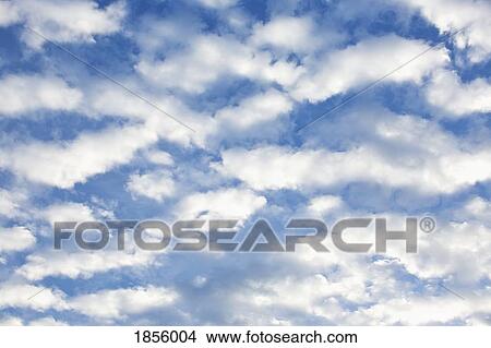 Fluffy white clouds in sunny blue sky View Large Photo Image Picture - Fluffy white clouds in sunny blue sky. Fotosearch