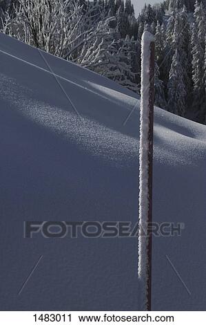 Frozen pole on snow covered mountain slope View Large Photo Image Stock Image - Frozen pole on snow covered mountain slope. Fotosearch