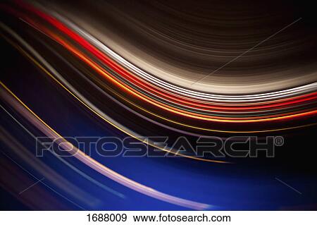 Stock Photo - Full frame abstract image of colorful light trails against black background. Fotosearch