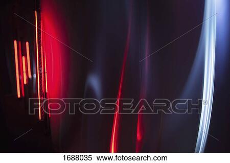 Stock Photography - Full frame abstract image of red and gray light trails against black background. Fotosearch