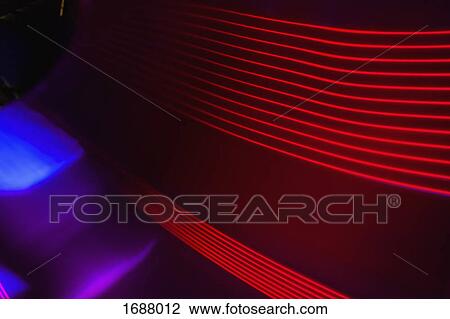 Stock Image - Full frame abstract image of red light trails. Fotosearch
