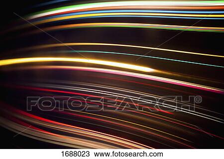 Stock Image - Full frame abstract image of various light trails against black background. Fotosearch
