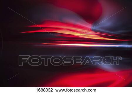 Stock Image - Full frame abstract image of vibrant red light trails. Fotosearch