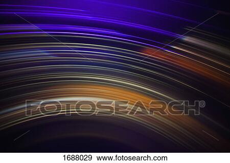 Stock Photo - Full frame abstract image of vibrant light trails against black background. Fotosearch