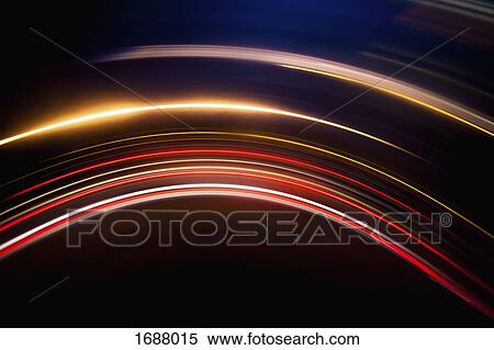 Stock Photography - Full frame abstract image of vibrant light trails against black background. Fotosearch