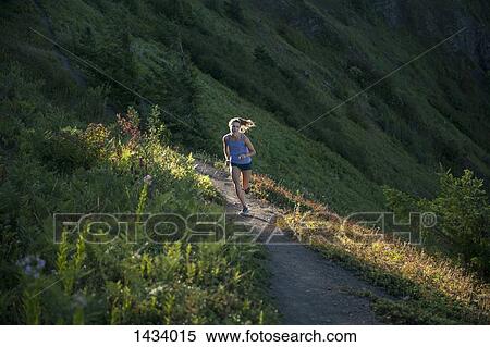 Full length of woman jogging on mountain path View Large Photo Image Stock Photography - Full length of woman jogging on mountain path. Fotosearch
