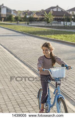 Girl cycling on footpath View Large Photo Image Stock Photography - Girl cycling on footpath. Fotosearch