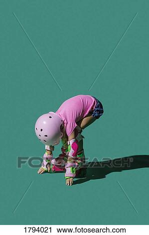 Girl roller skating against green background View Large Photo Image Stock Image - Girl roller skating against green background. Fotosearch