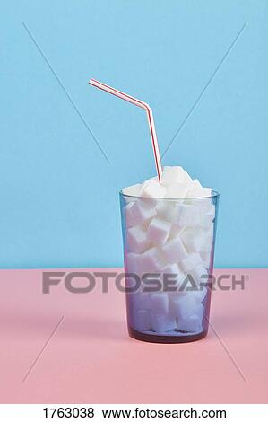 Glass filled with sugar cubes and straw View Large Photo Image Stock Photo - Glass filled with sugar cubes and straw. Fotosearch