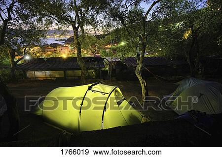 Stock Photo - Glowing campsite tent at dusk, Tellaro, Tuscany, Italy. Fotosearch