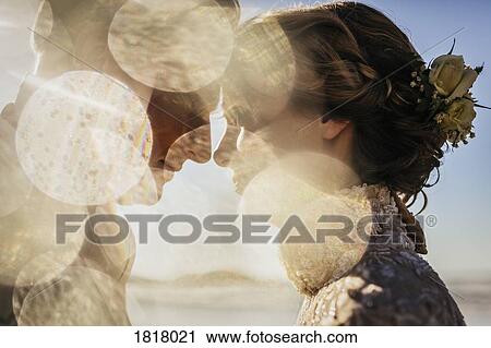 Golden light illuminating profile of bride and groom View Large Photo Image Stock Image - Golden light illuminating profile of bride and groom. Fotosearch