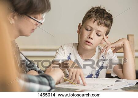 Grandmother teaching grandson on table at home View Large Photo Image Picture - Grandmother teaching grandson on table at home. Fotosearch