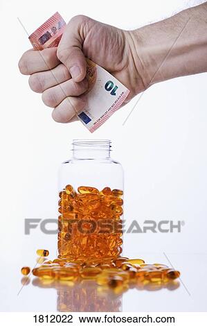 Hand clenching ten Euro banknote over bottle of medicine capsules View Large Photo Image Stock Image - Hand clenching ten Euro banknote over bottle of medicine capsules. Fotosearch