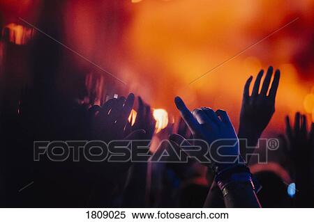 Hands raised, cheering in concert audience View Large Photo Image Stock Photography - Hands raised, cheering in concert audience. Fotosearch