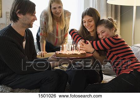 Stock Photograph - Happy family celebrating a birthday at home. Fotosearch