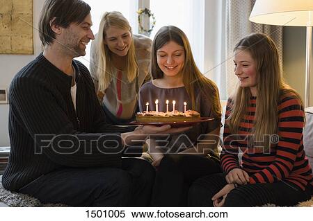Happy family with birthday cake at home View Large Photo Image Stock Photography - Happy family with birthday cake at home. Fotosearch